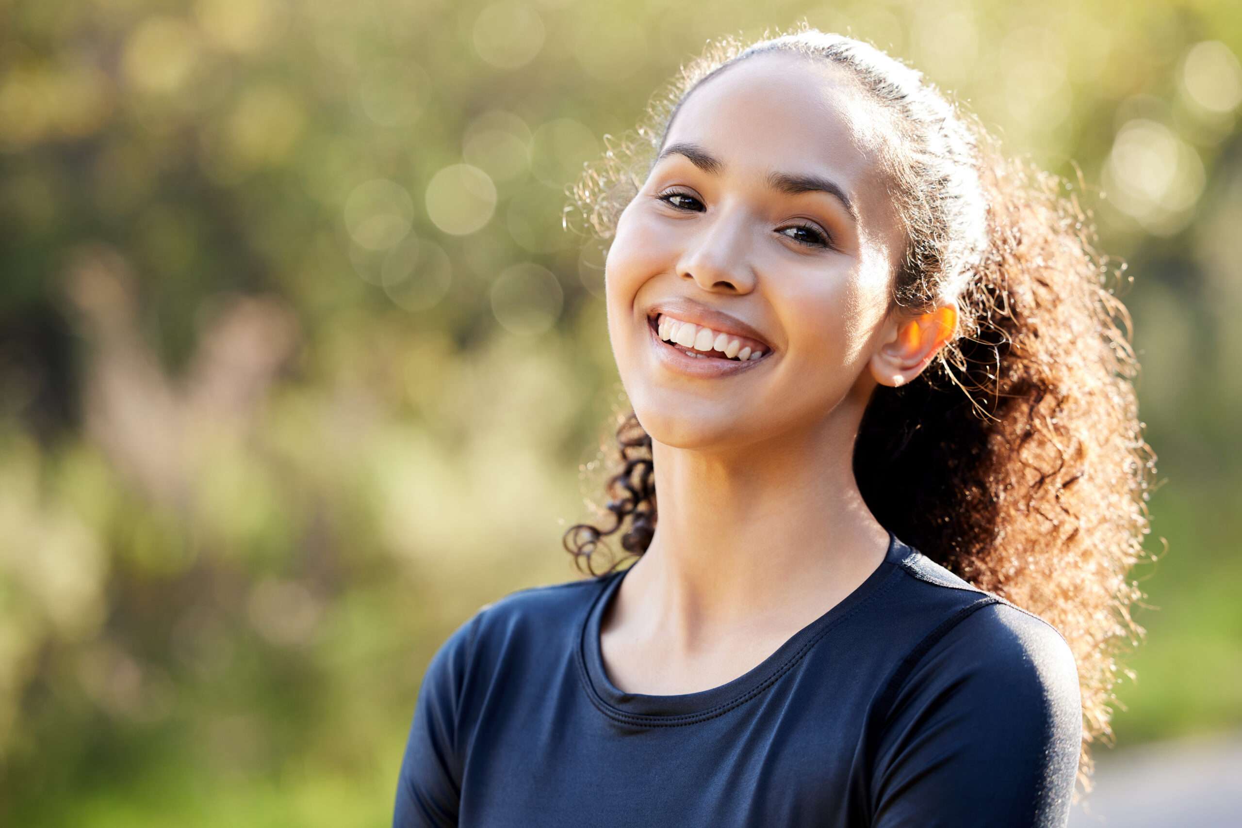 Young woman smiling confidently after completing her orthodontic treatment journey.